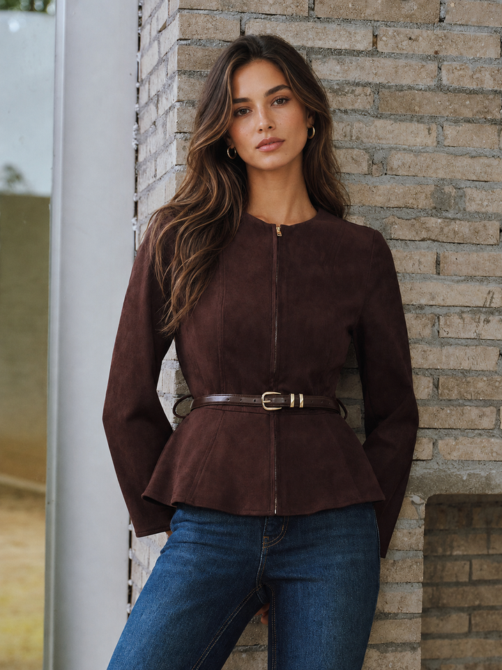 Woman in belted brown suede effect jacket with flared peplum hem and jeans