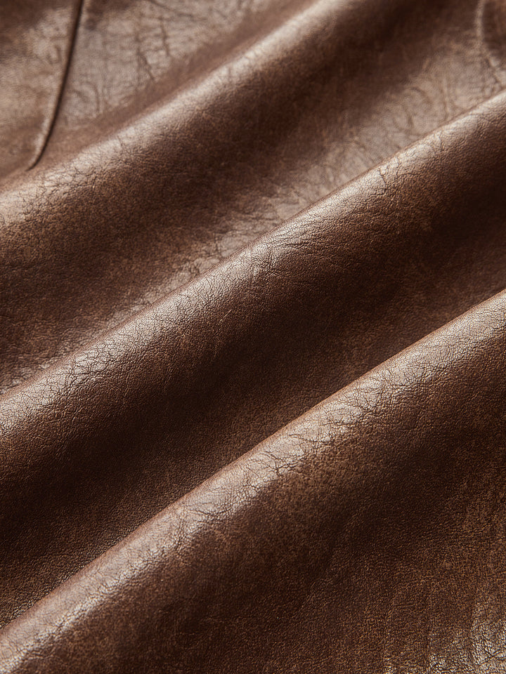 Fabric detail of soft brown faux leather with subtle vintage sheen