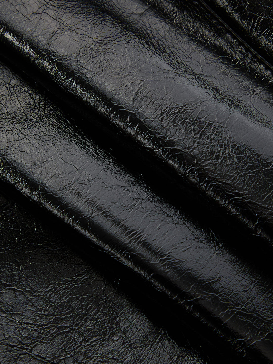 Close-up of the crackle texture on the black faux leather sleeve