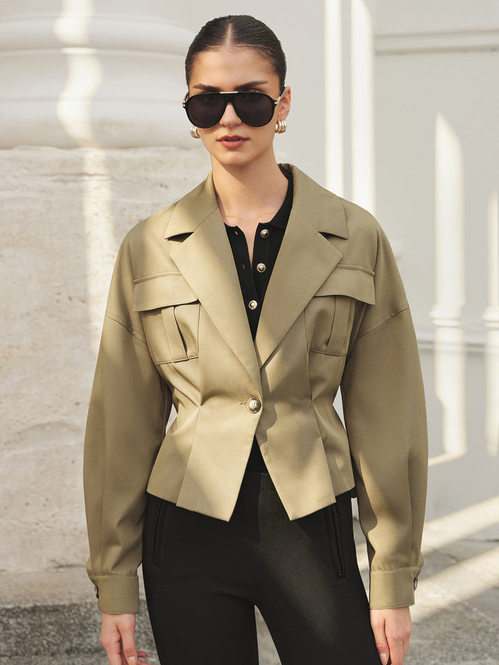 Front portrait of the khaki lapel jacket worn open over a black blouse