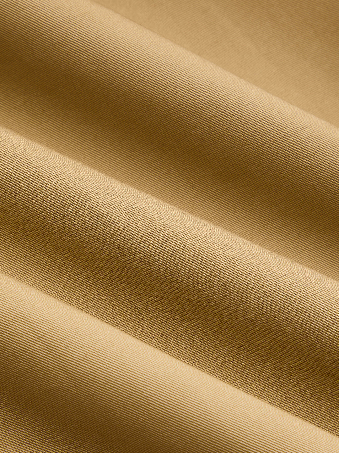 Macro of the khaki cotton twill fabric showing its diagonal weave
