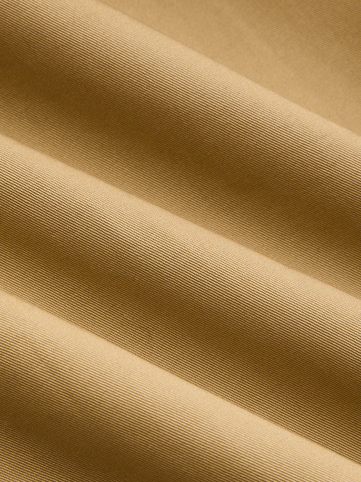 Macro of the khaki cotton twill fabric showing its diagonal weave