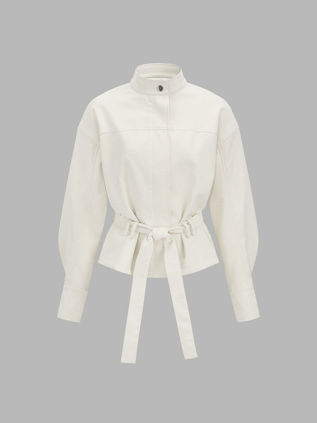 Front product view of ivory leather look jacket with stand collar and tie belt