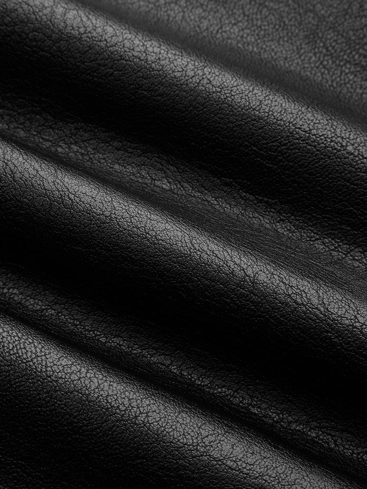 Macro of the pebbled black vegan leather fabric with deep folds