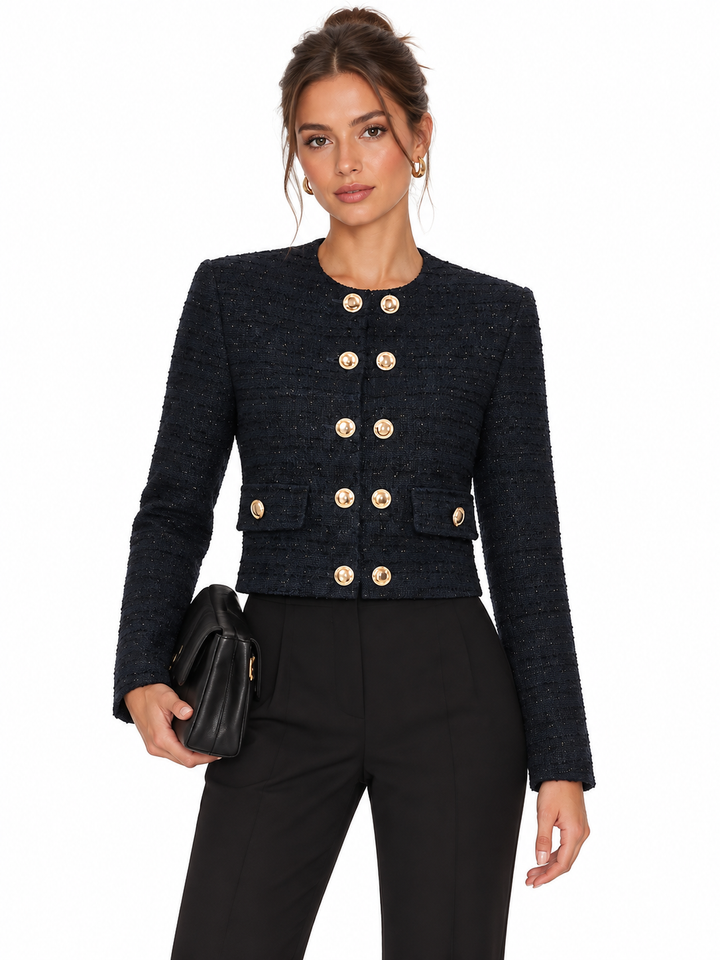 Model wearing a navy sparkle tweed cropped jacket with gold buttons and black trousers