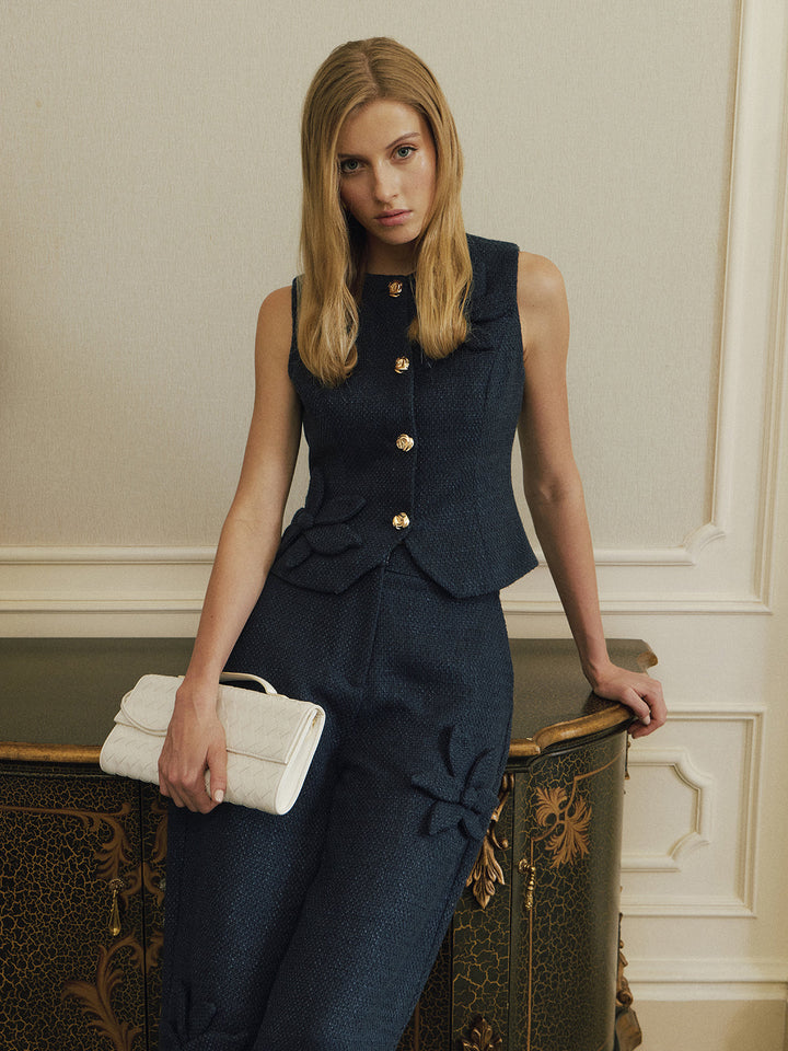 Front view of dark blue tweed waistcoat with round neck and peplum hem