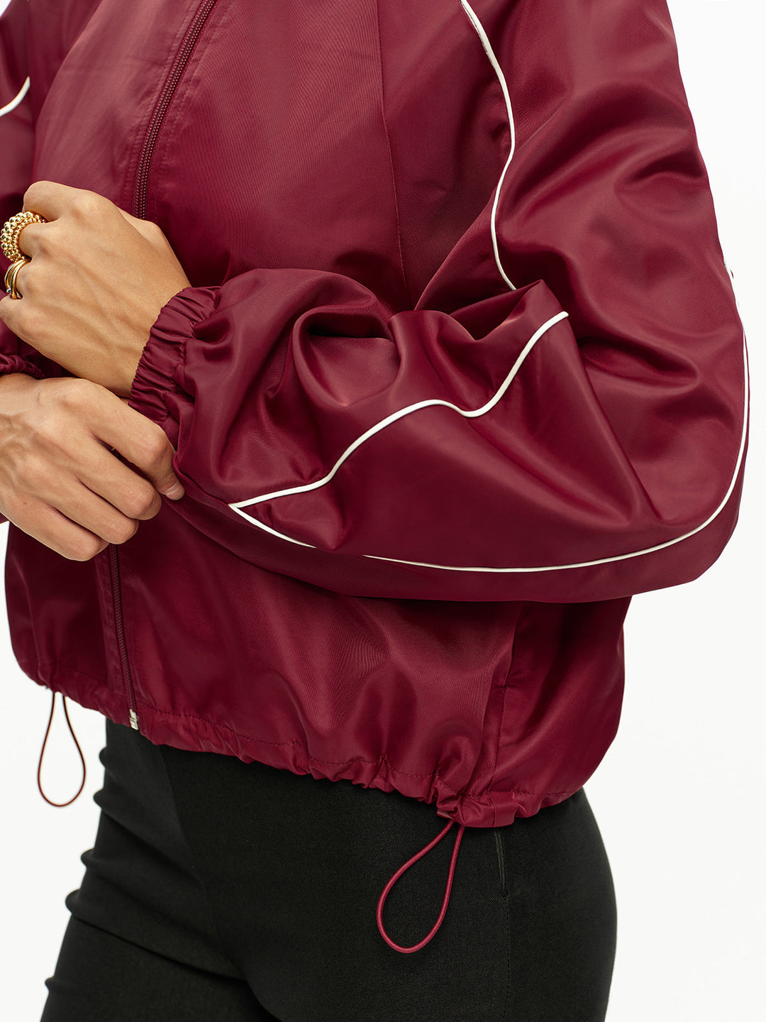 Detail of the elasticated cuff and drawstring hem of the wine track jacket