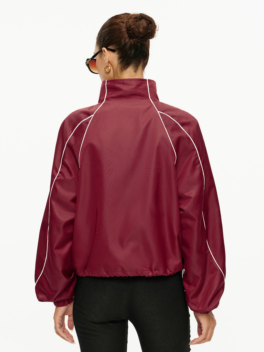 Back view of the wine red track jacket showing piped raglan sleeve seams