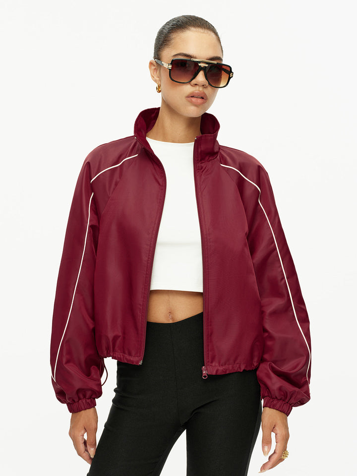 Front view of wine red zip-up track jacket with white piping and stand collar