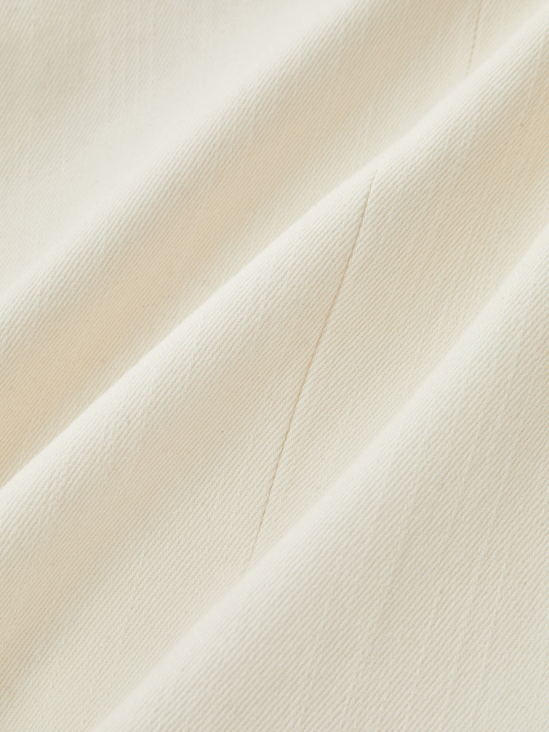 Fabric close-up showing the soft ivory cotton twill weave of the napoleon lace jacket