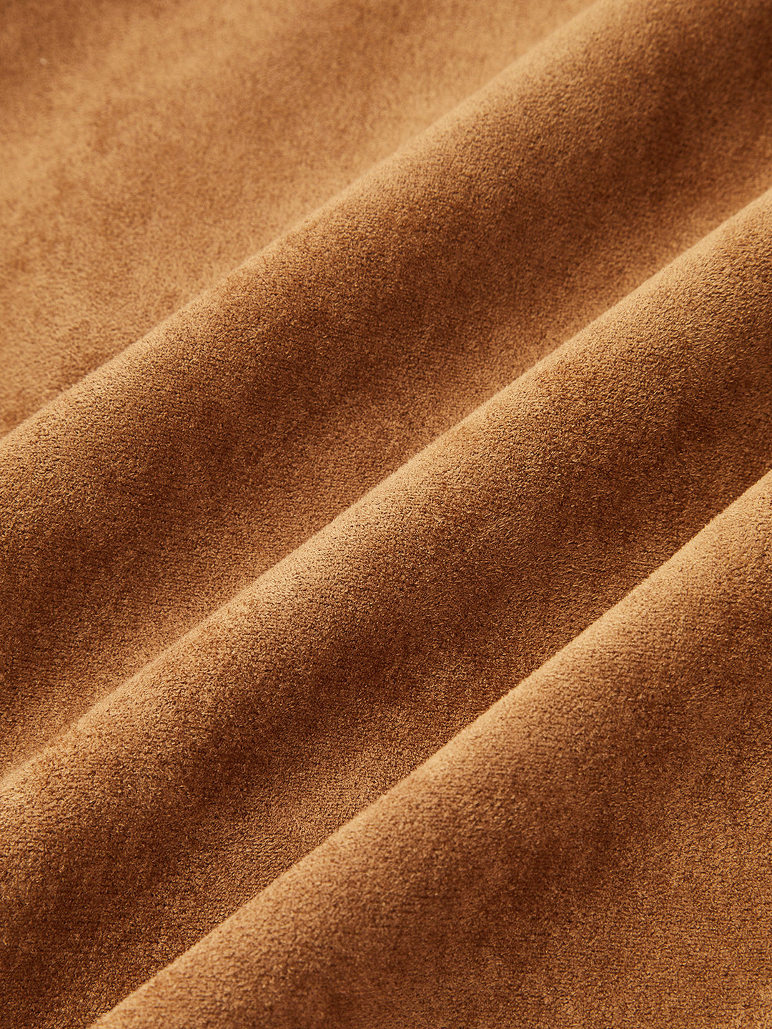 Close-up of soft tan suede effect fabric with velvety texture