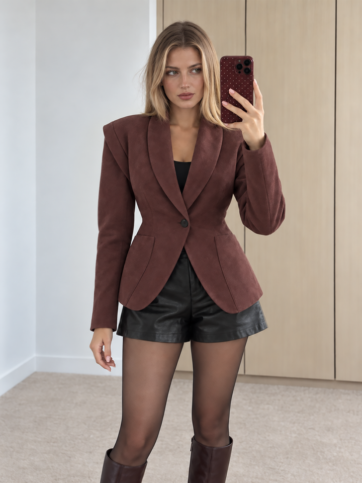 Woman wearing the wine suede blazer with black leather shorts and knee high boots
