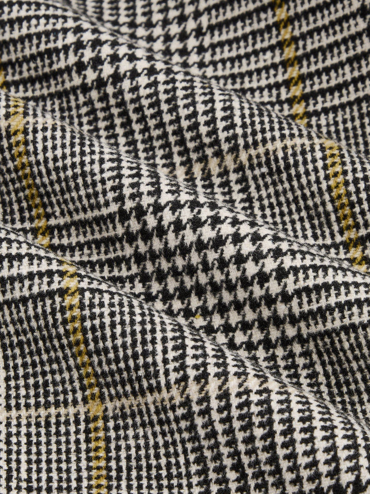 Fabric detail of black, white and yellow houndstooth check weave