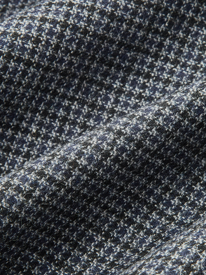 Fabric detail of the grey and navy houndstooth wool blend