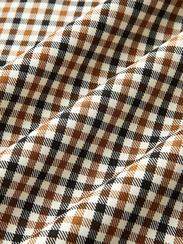 Fabric close-up of the brown, black and cream houndstooth check lining