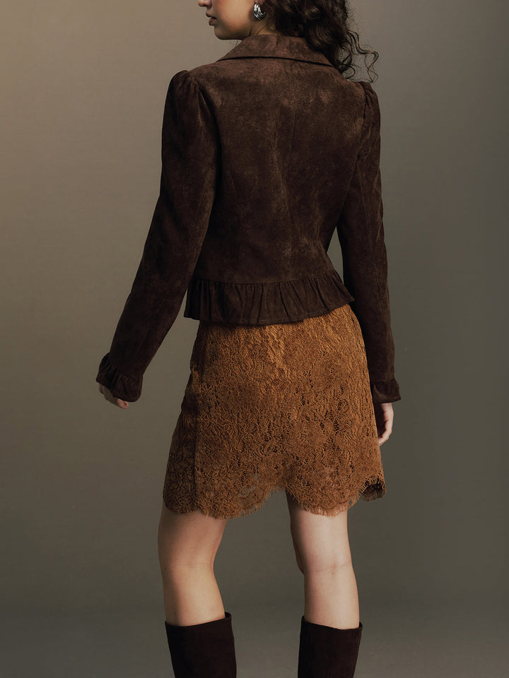 Three-quarter back view of the fitted brown suede jacket with ruffle trim at the waist
