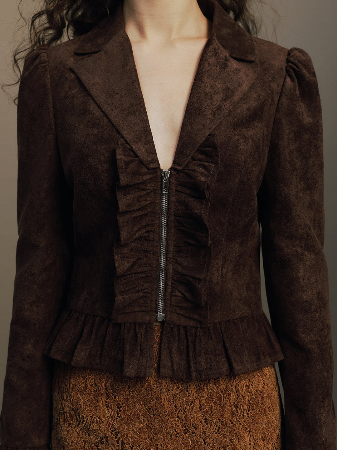 Close front view showing the ruched zip placket and notch collar of the suede jacket