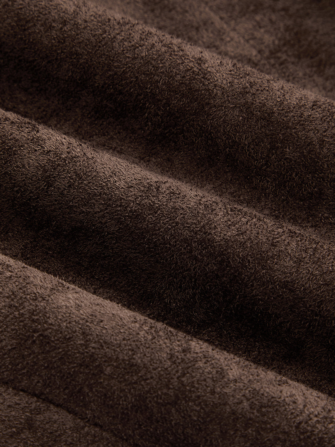 Macro of the brushed brown faux suede fabric showing its soft nap texture