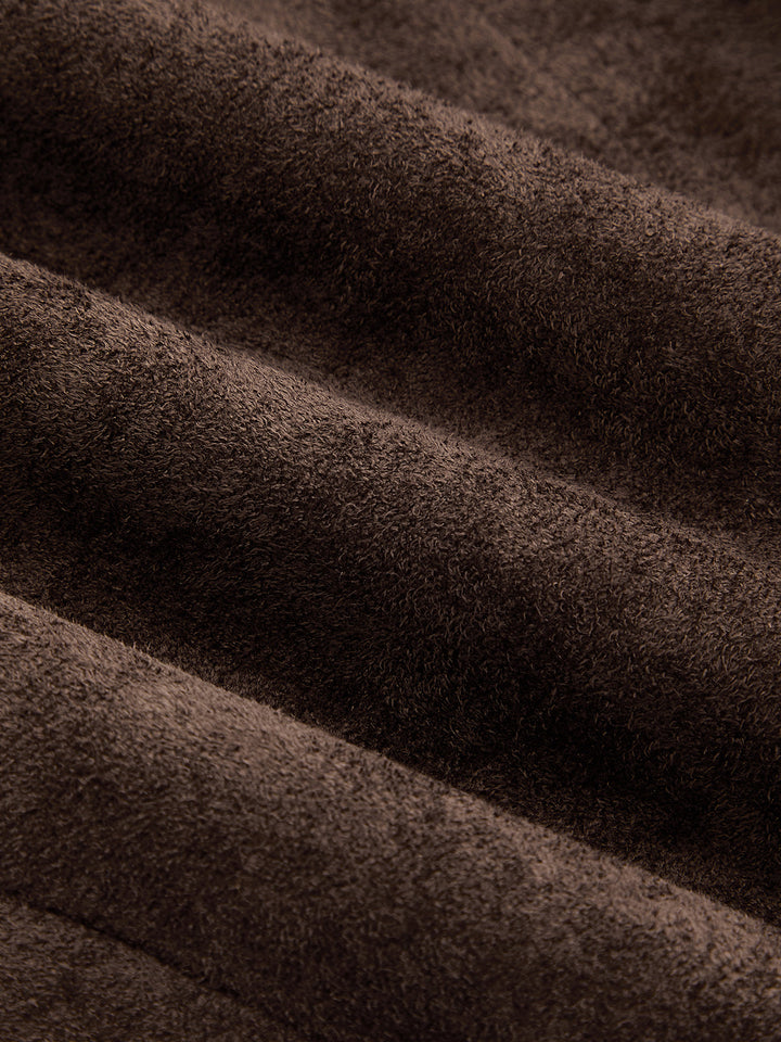 Macro of the brushed brown faux suede fabric showing its soft nap texture