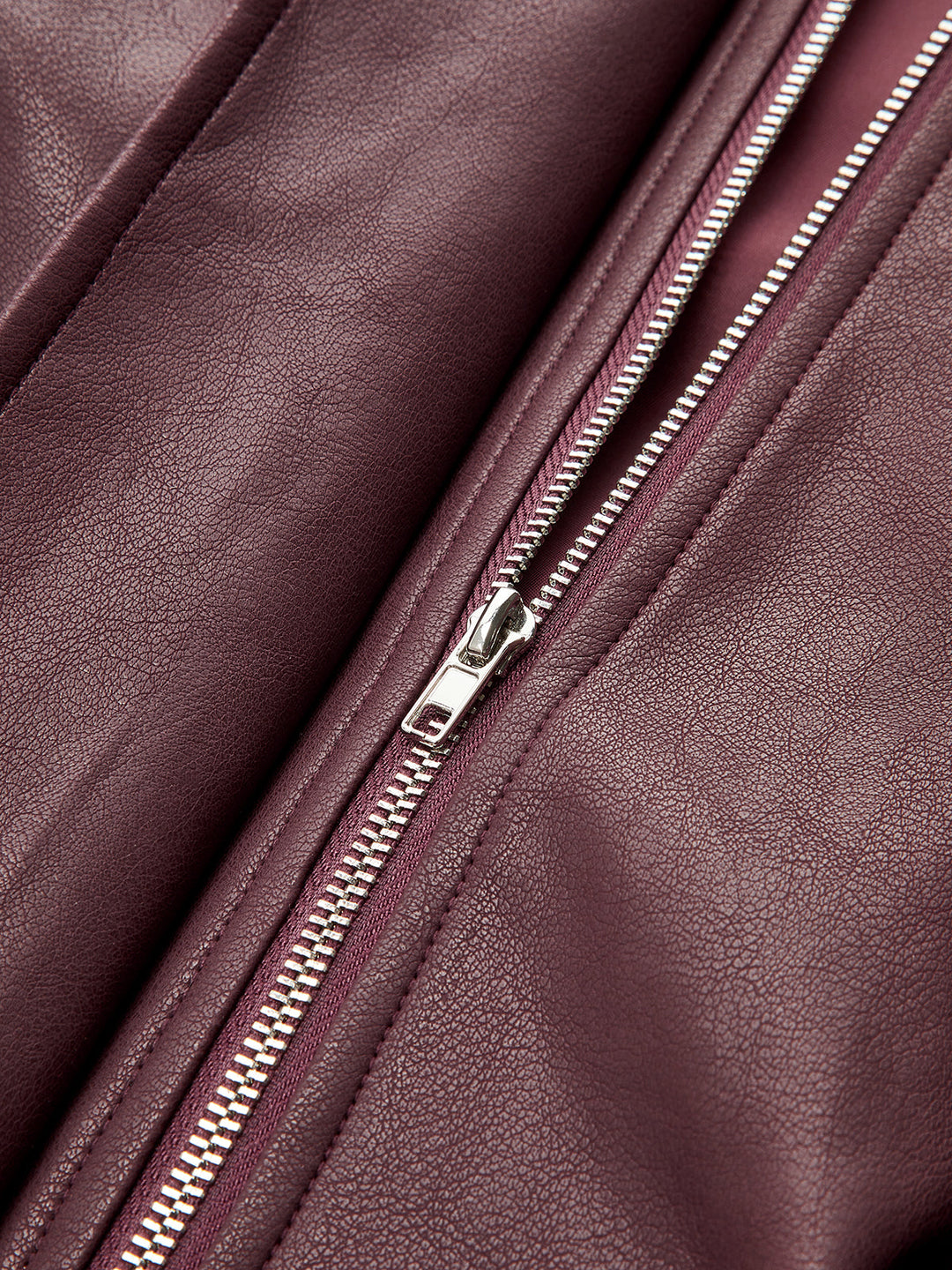 Close-up of the silver front zip on the deep wine leather look fabric