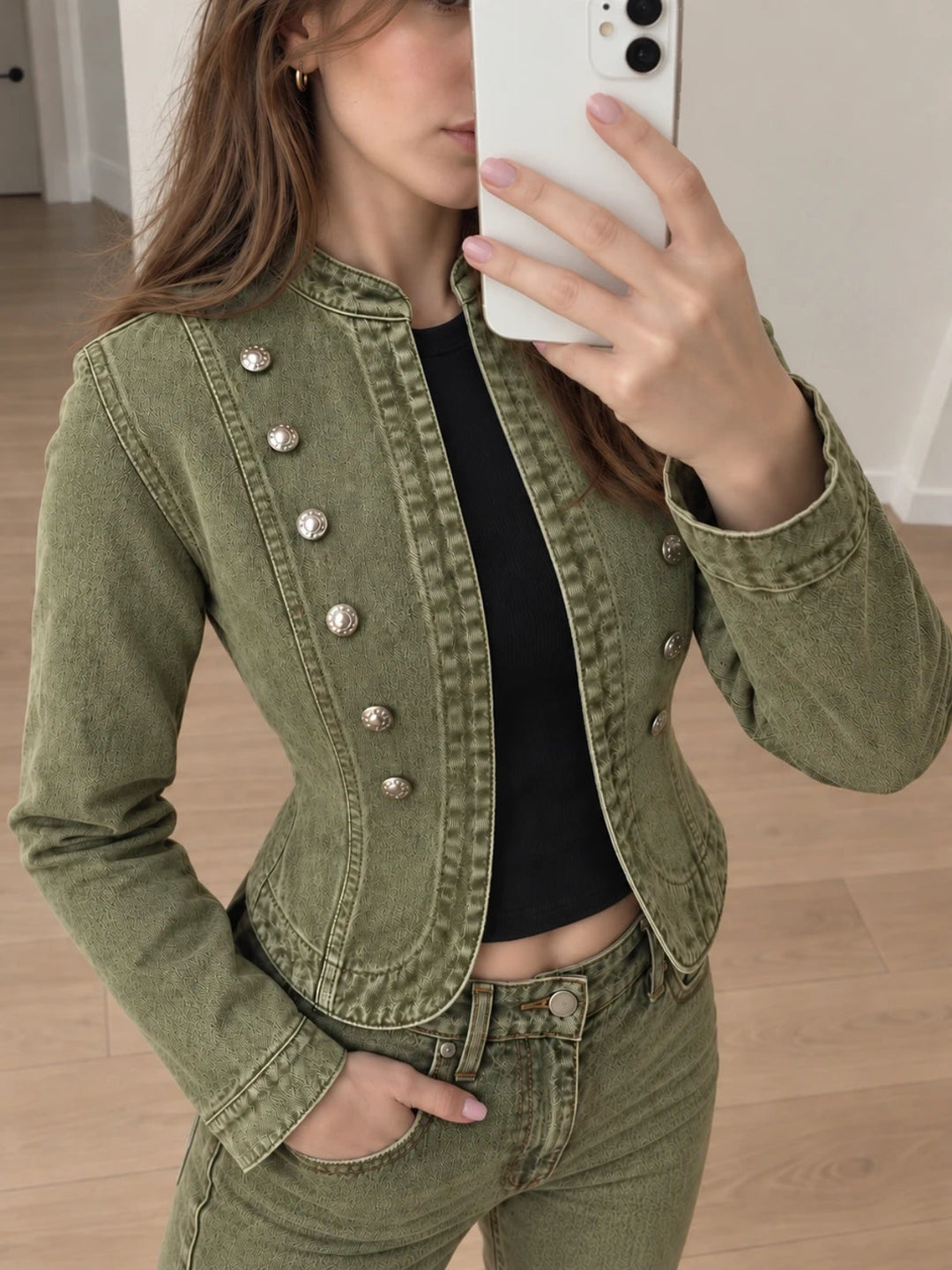Mirror selfie of woman in olive green Napoleon style cropped denim jacket