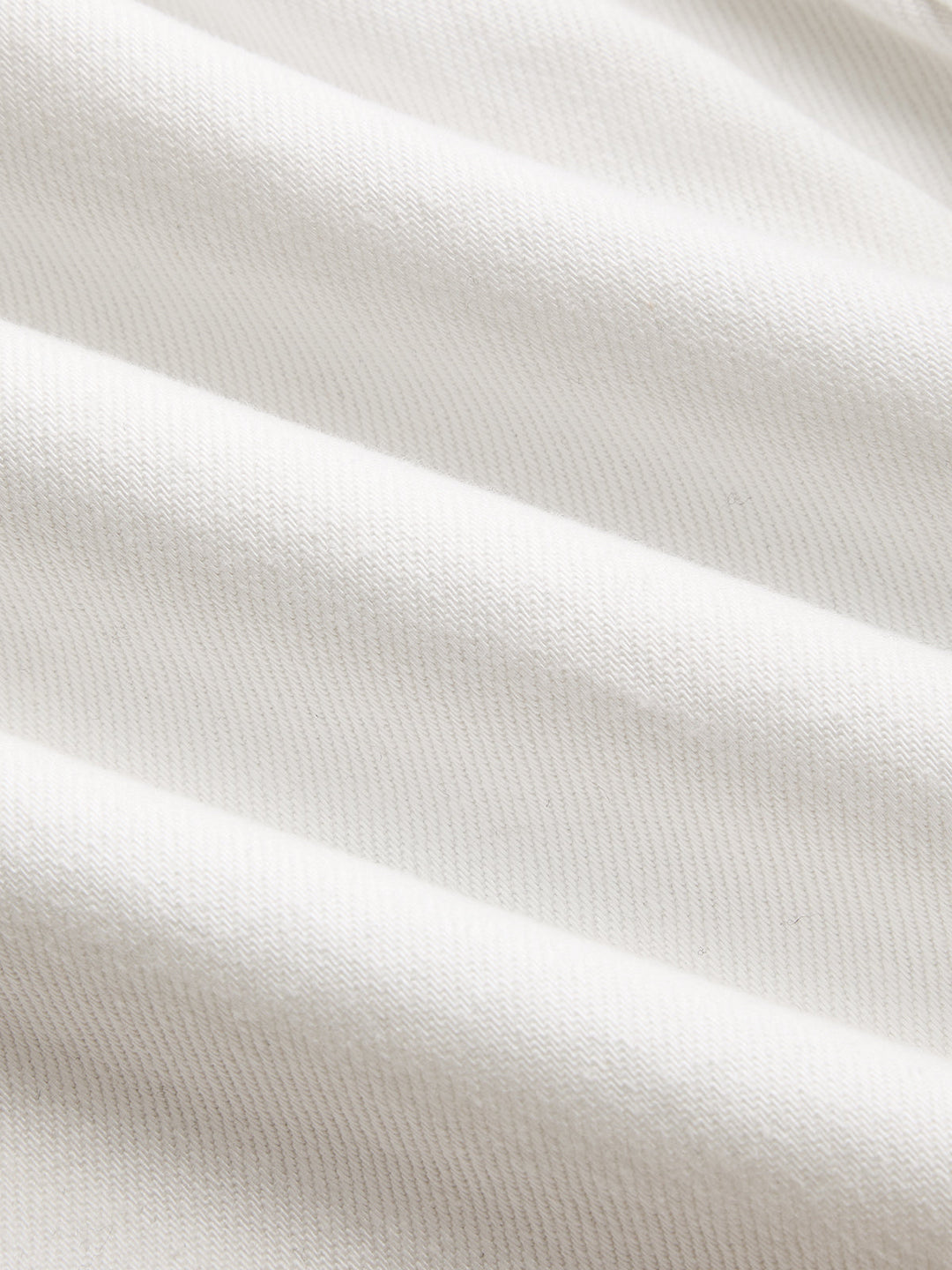 Macro shot of the off-white cotton denim twill used for this women's utility jacket
