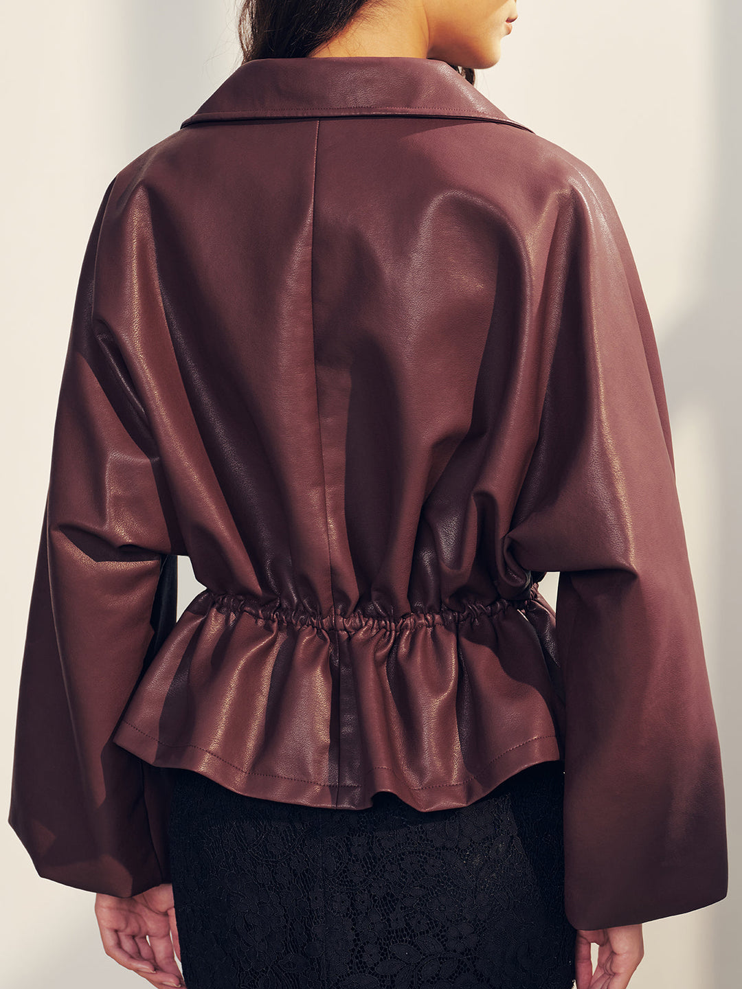 Back view of the burgundy jacket showing flared peplum and dropped shoulders