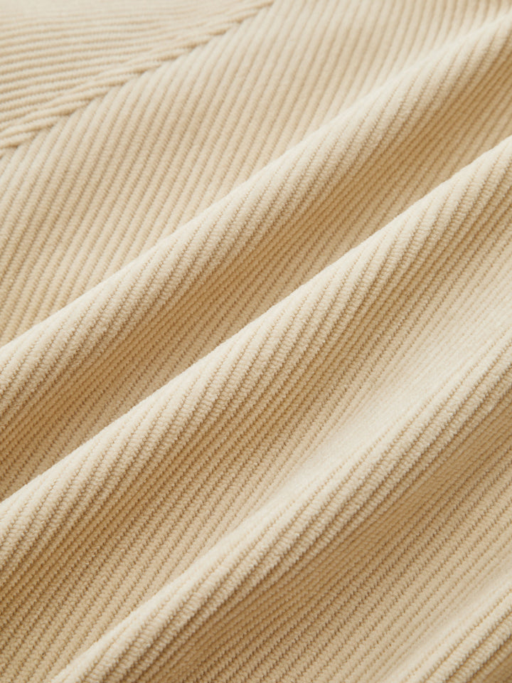 Fabric close-up of the fine beige corduroy ribbing
