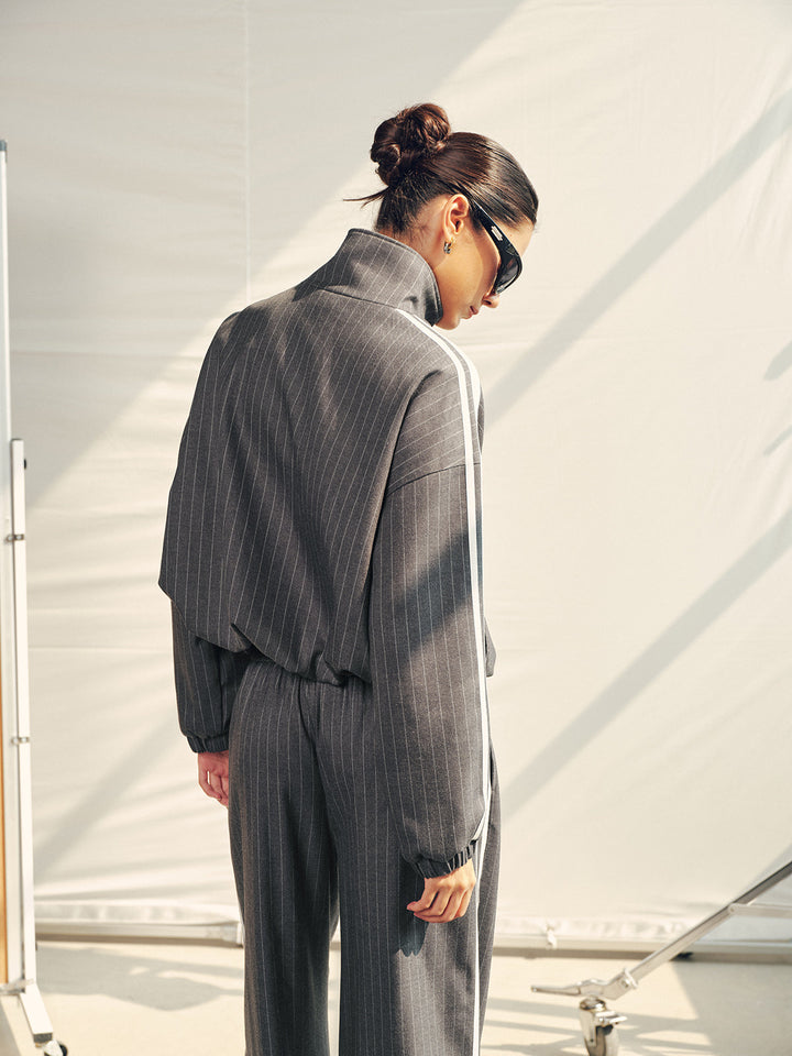 Back view of the oversized pinstripe track jacket and matching trousers