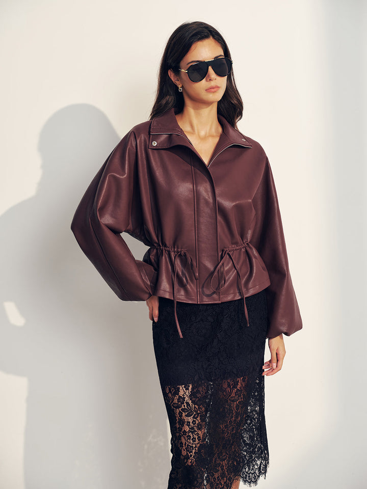 Full-length street shot of the burgundy drawstring jacket with black lace midi skirt