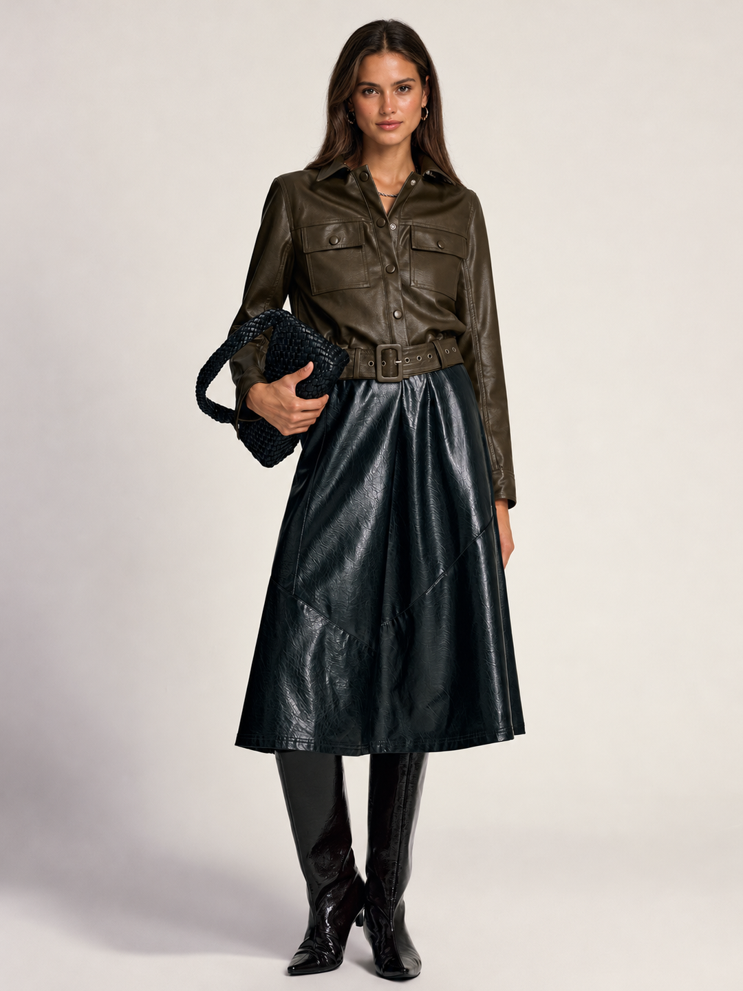 Full length styling shot of the belted cargo shirt jacket with leather skirt and black boots