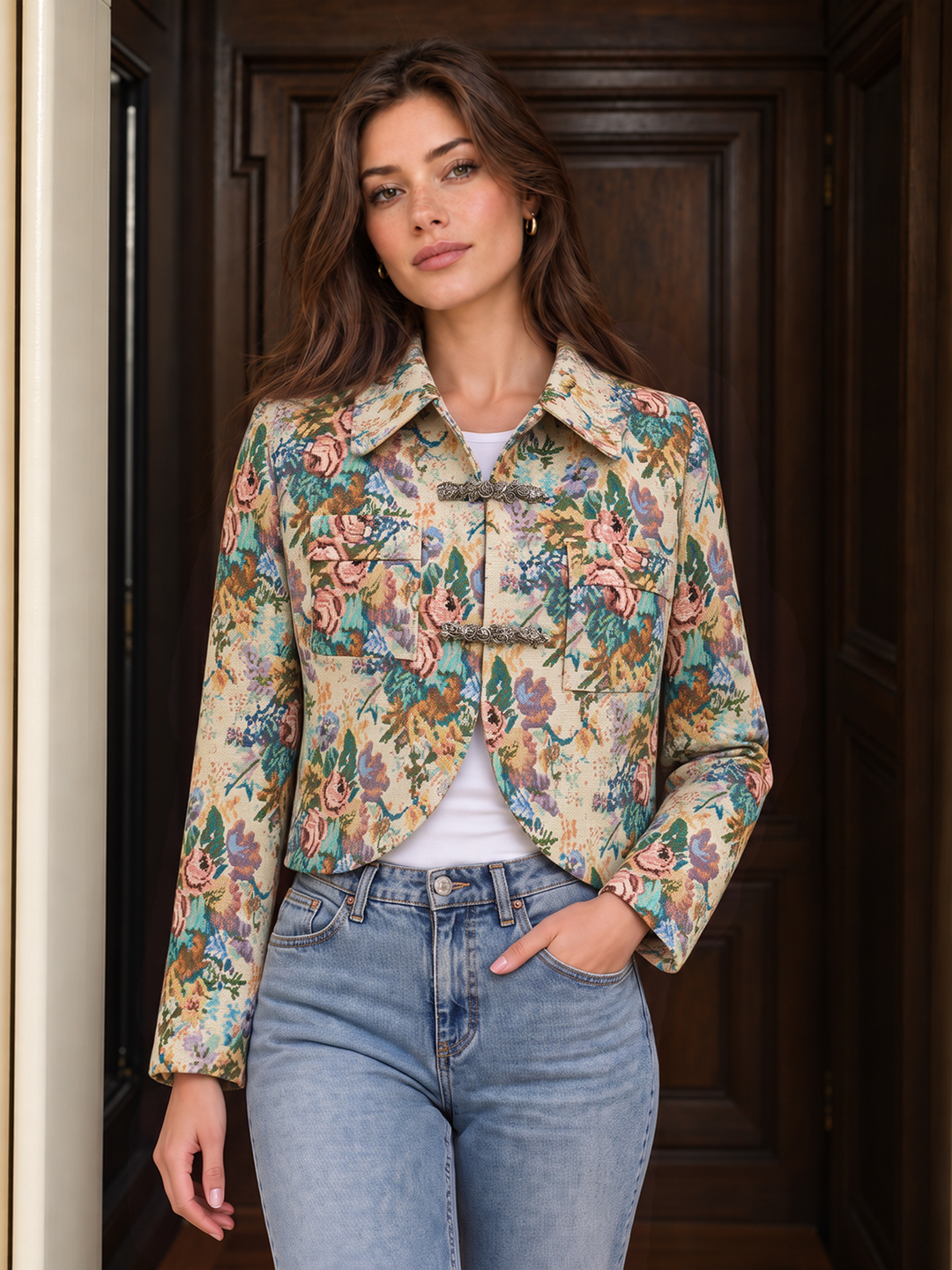 Model in a floral jacquard cropped jacket with pointed collar and blue jeans