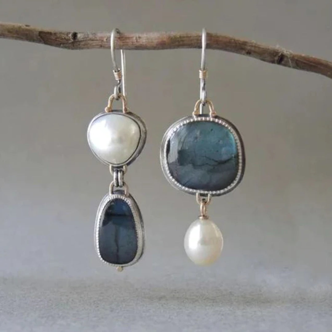Elegant blue pearl earrings shown on a plain background