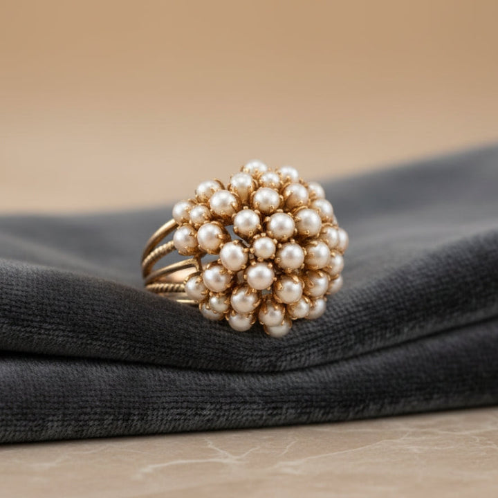 Pearl gold ring displayed alongside other jewellery pieces