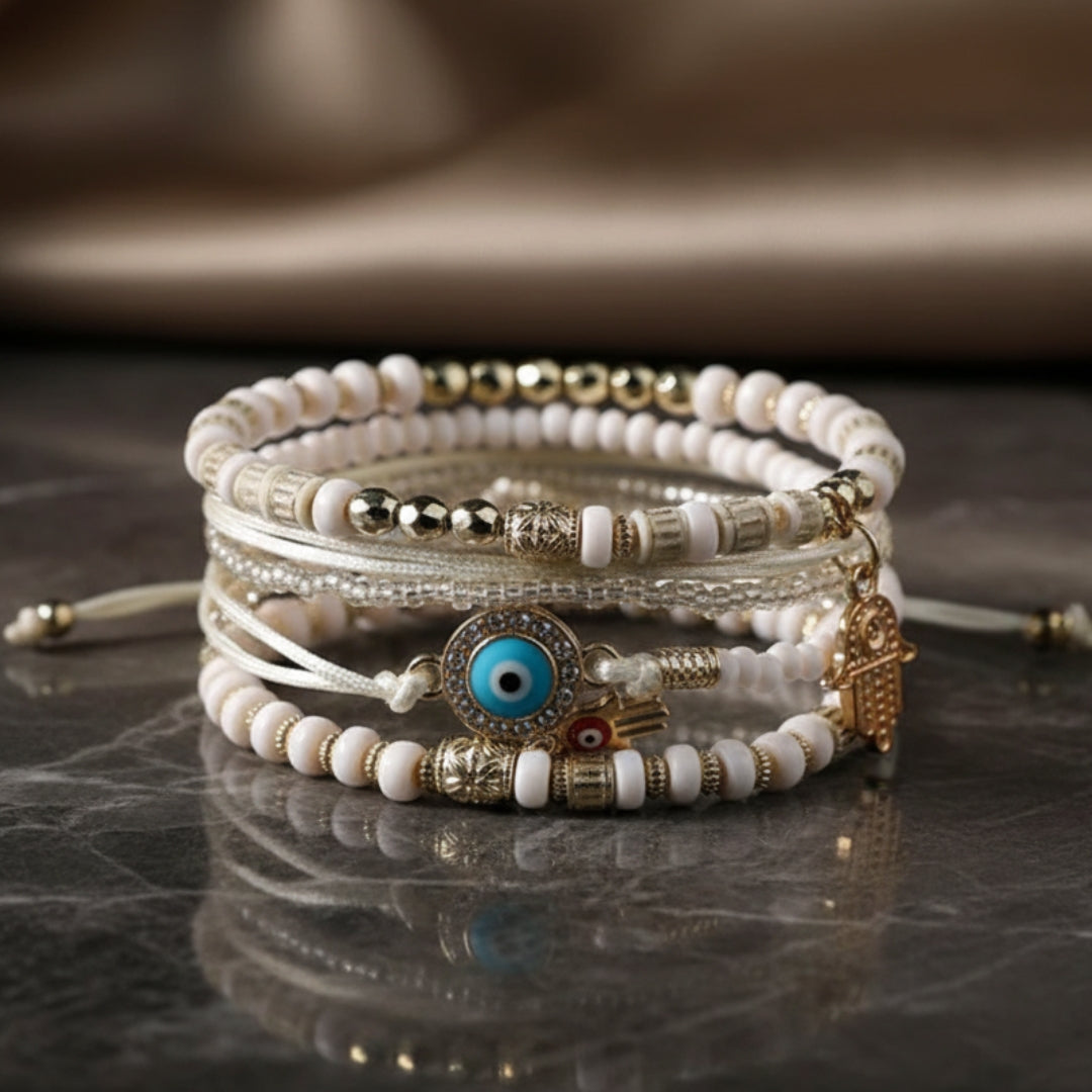 Gold hamsa bracelet bundle stacked on a model's wrist