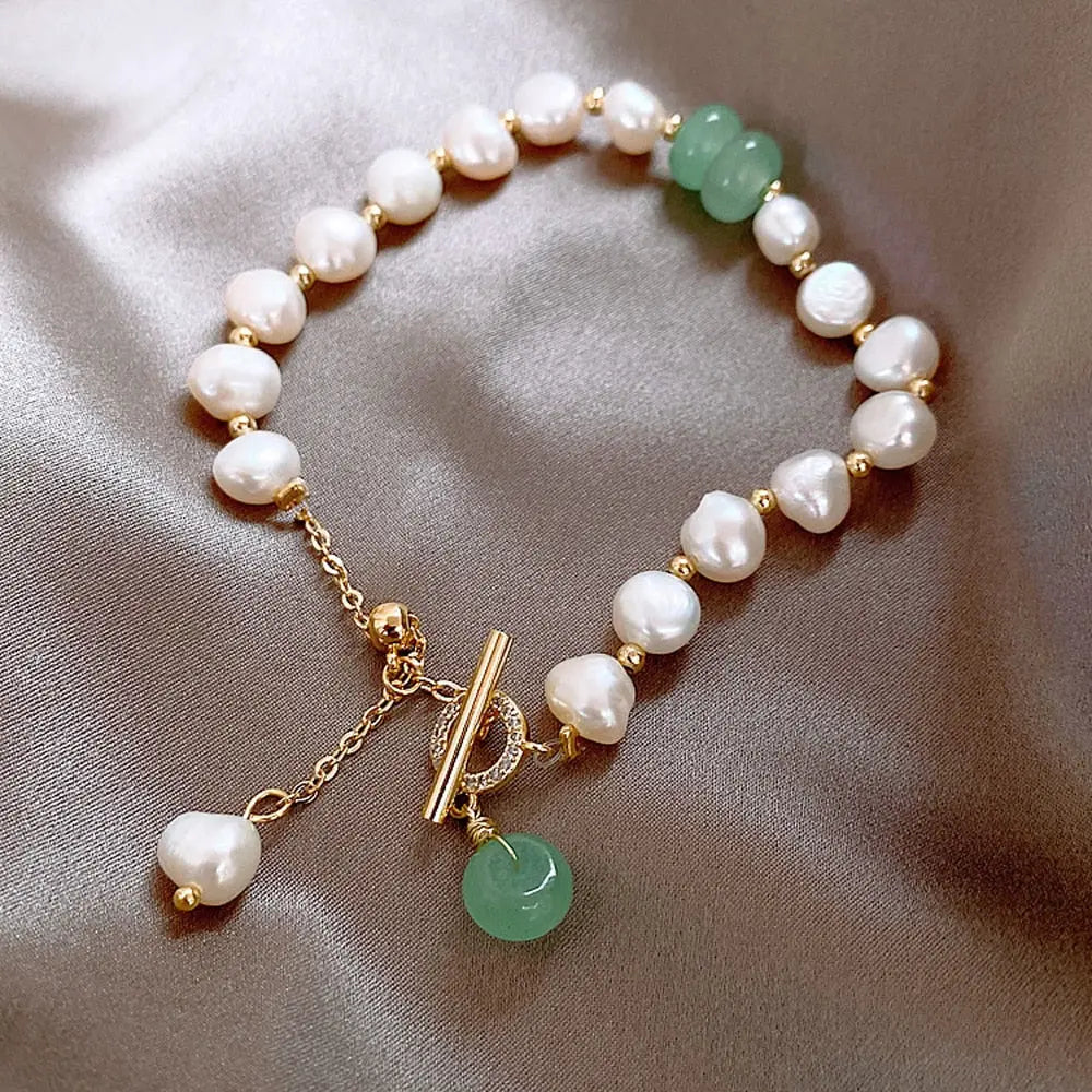 Close-up of alternating jade and pearl beads on the bracelet