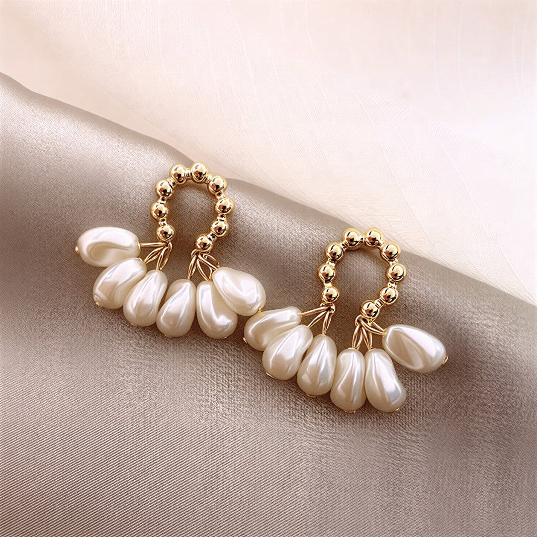 Pearl flower hoop earring shown in close-up against a plain background