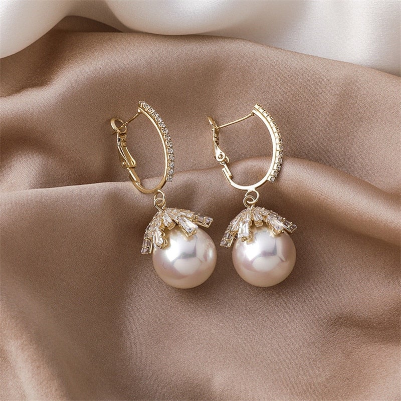 Close-up of the small pearl stud earrings