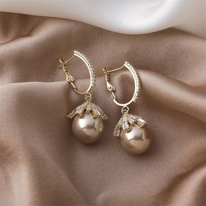 Pearl baby stud earrings shown on a white background