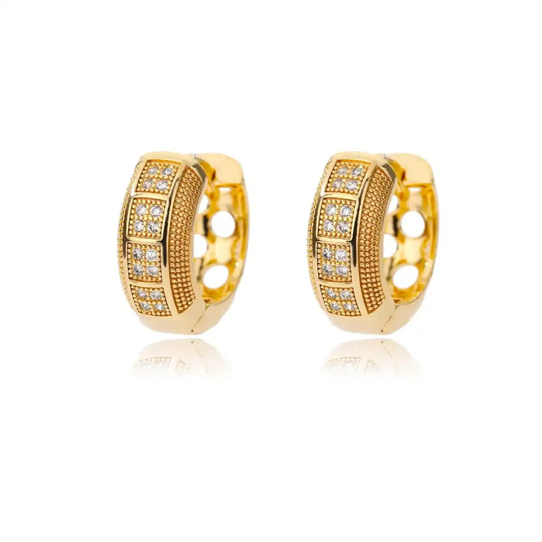 Earrings laid flat on a neutral background