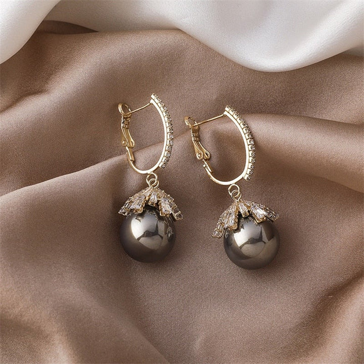 Pearl baby stud earrings photographed from a side view
