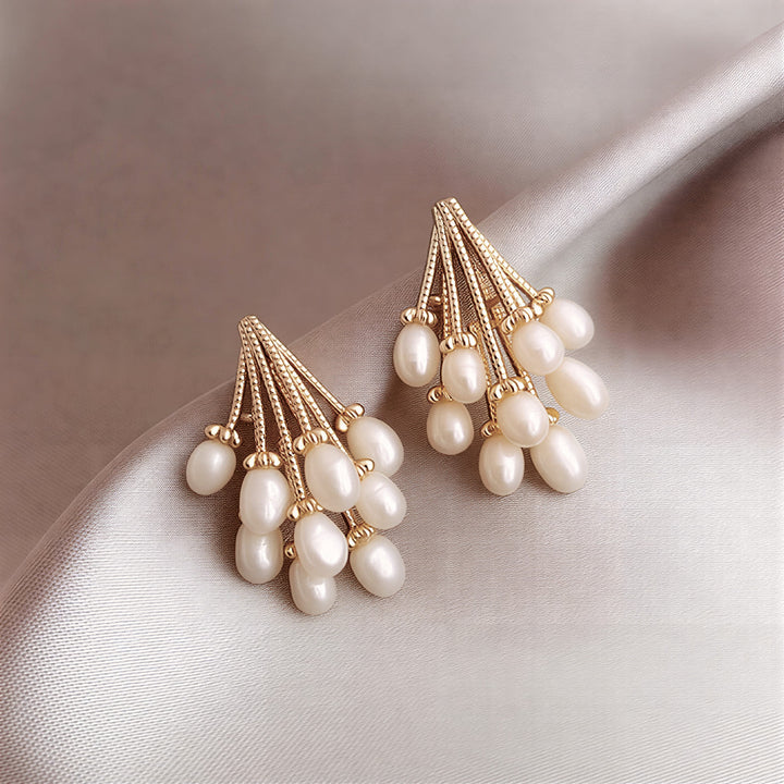 Pearl rain earrings with cascading pearl strands on white background