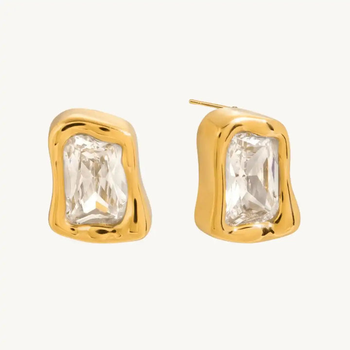 Earrings laid flat on a neutral background