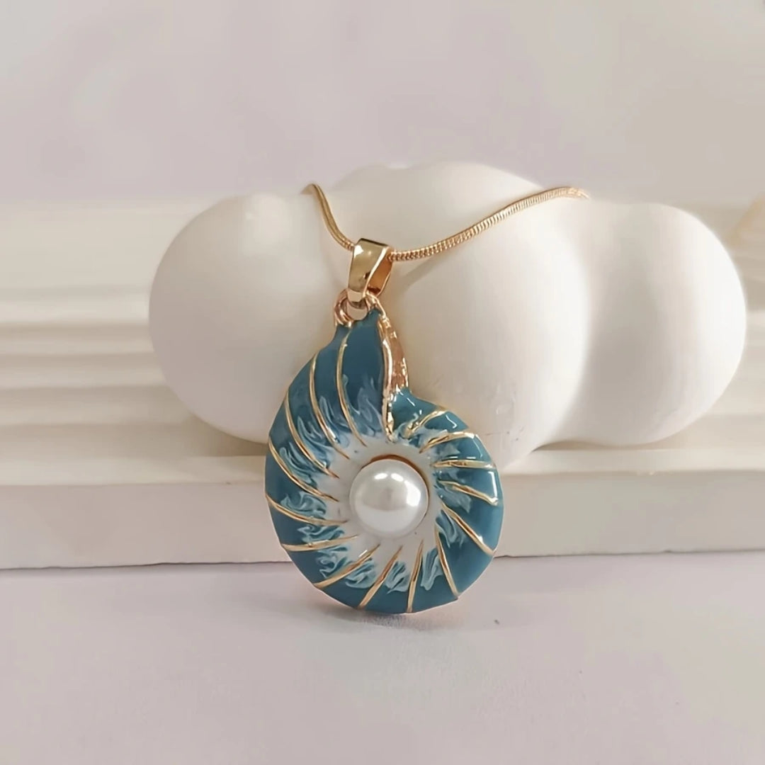 Seashell pearl pendant necklace laid flat on a plain background
