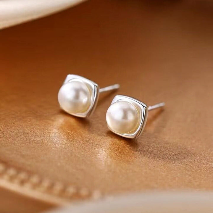 Classic freshwater pearl drop earrings shown on a white background