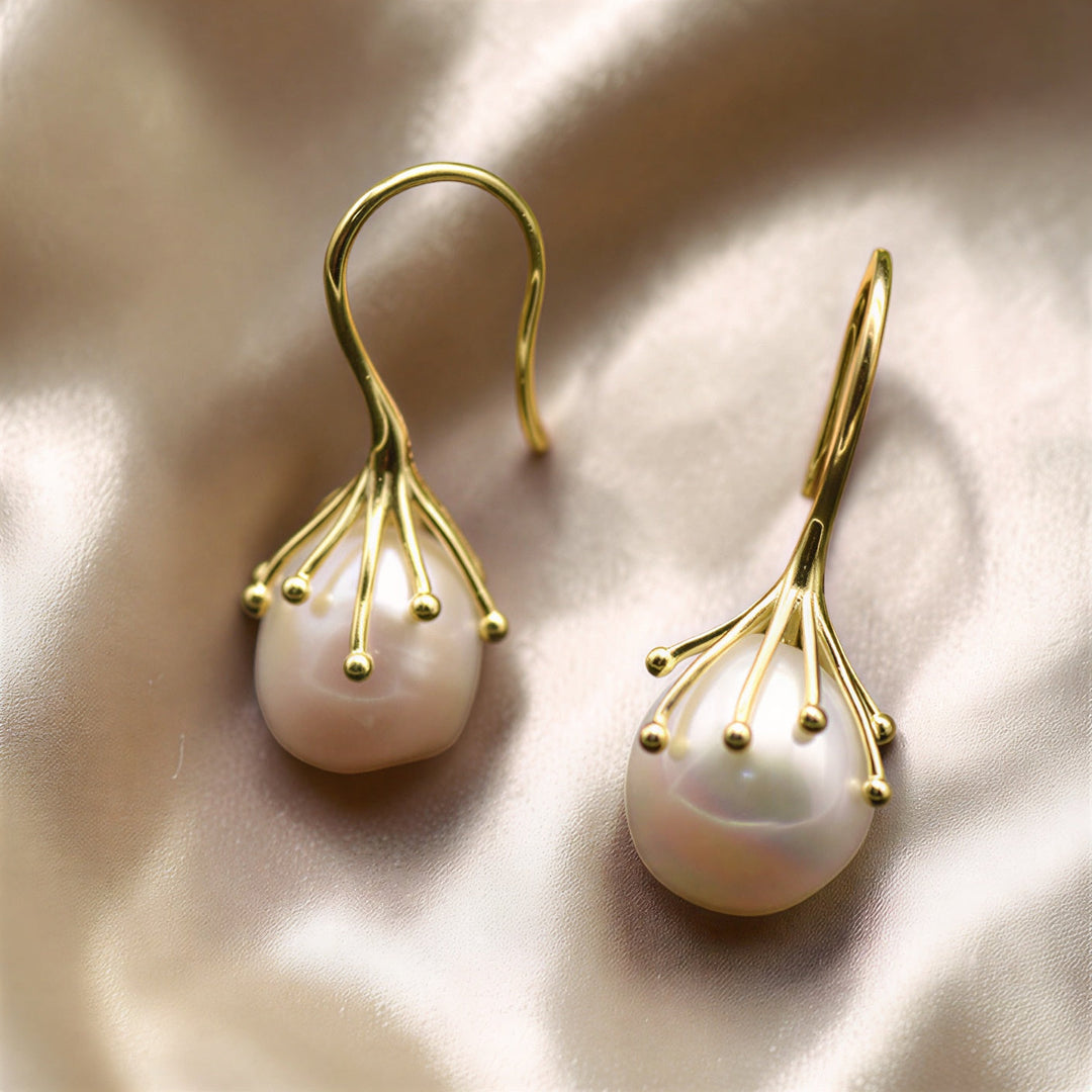 Baroque pearl drop earrings shown together on a white background
