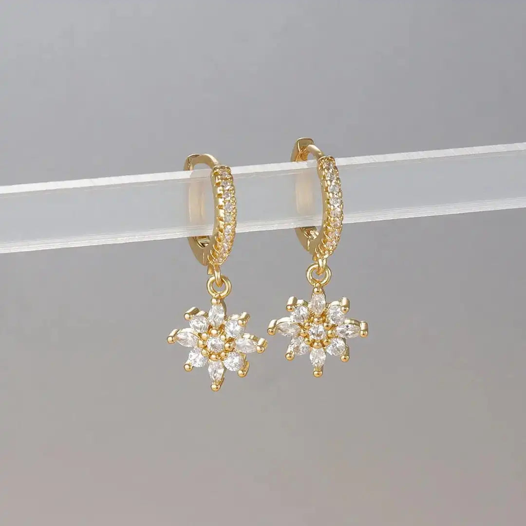 Earrings laid flat on a neutral background