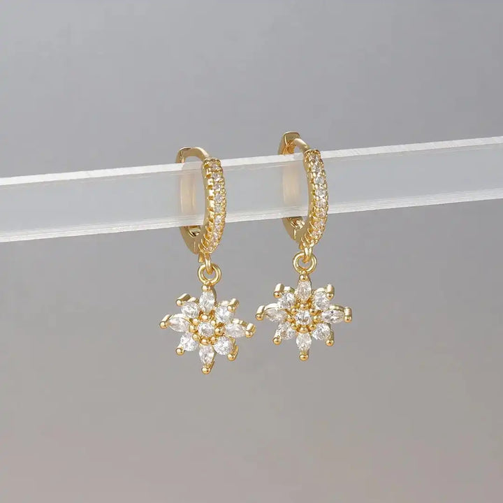 Earrings laid flat on a neutral background