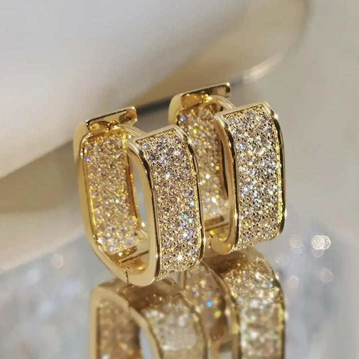 Main shot of the paved zirconia huggie hoop earrings
