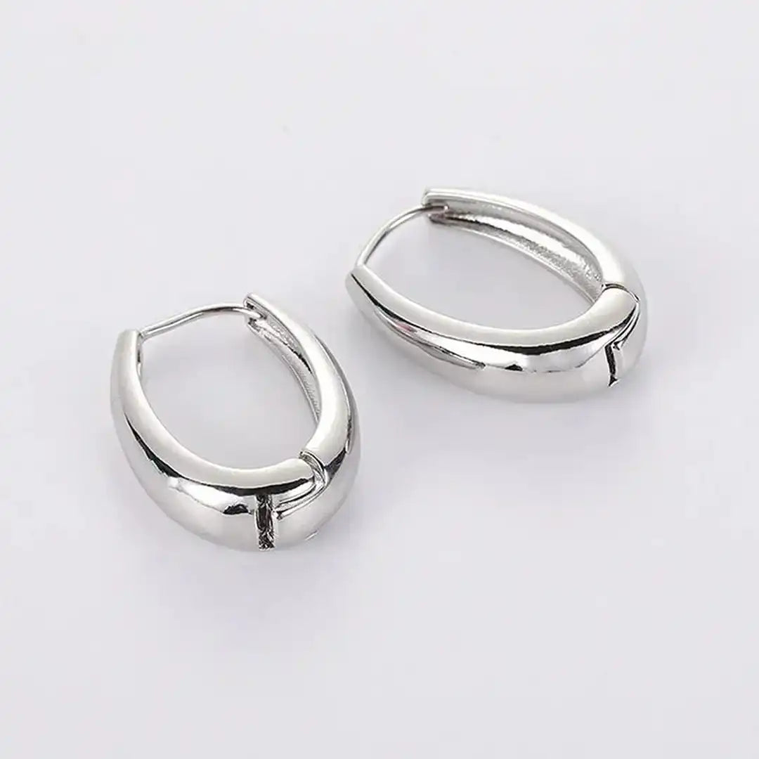 Earrings laid flat on a neutral background